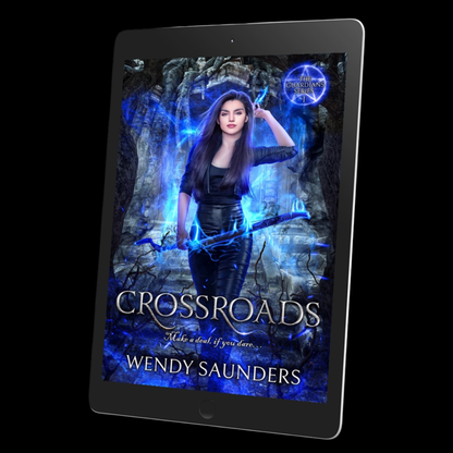 A tablet device displaying a fantasy book cover titled "Crossroads" by Wendy Saunders, set against a solid black background.