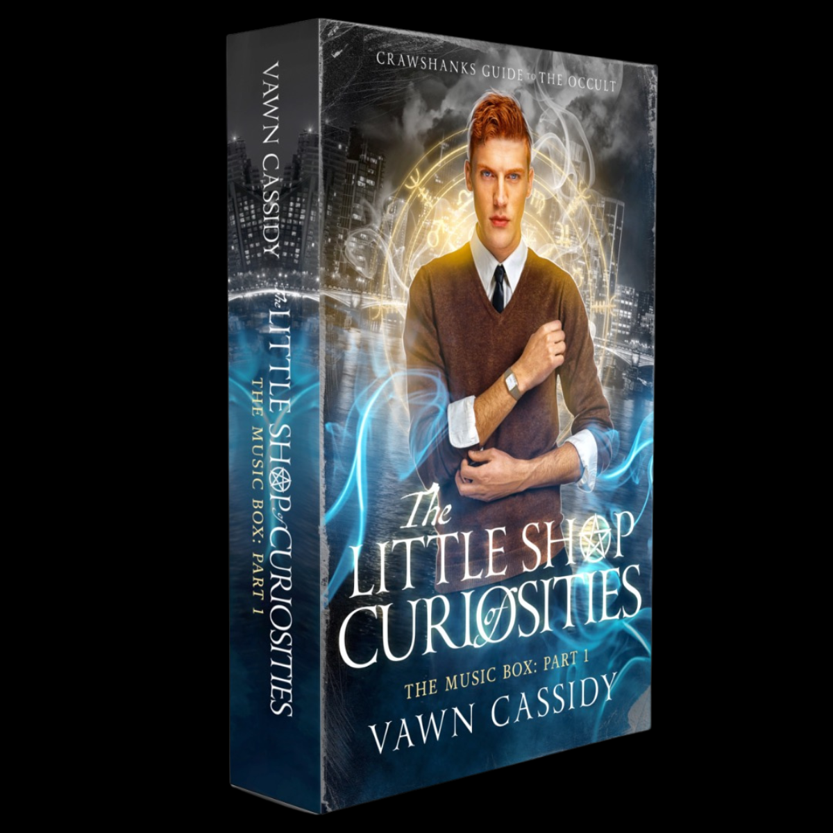 A boxed music box/book package titled "The Little Shop Curiosities: The Music Box, Part 1" by Vawn Cassidy, shown at a slight angle on a black background. The front cover features a young man in a brown sweater and white shirt with blue glowing effects, and the spine repeats the title and author name.